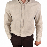 A man wearing a light beige linen long-sleeve button-down shirt and dark brown shorts, shown from the chin down against a plain white background.