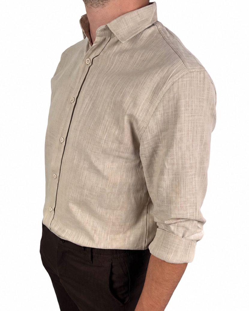 A man wearing a light beige linen long-sleeve button-down shirt and dark brown shorts, shown from a side profile against a white background.