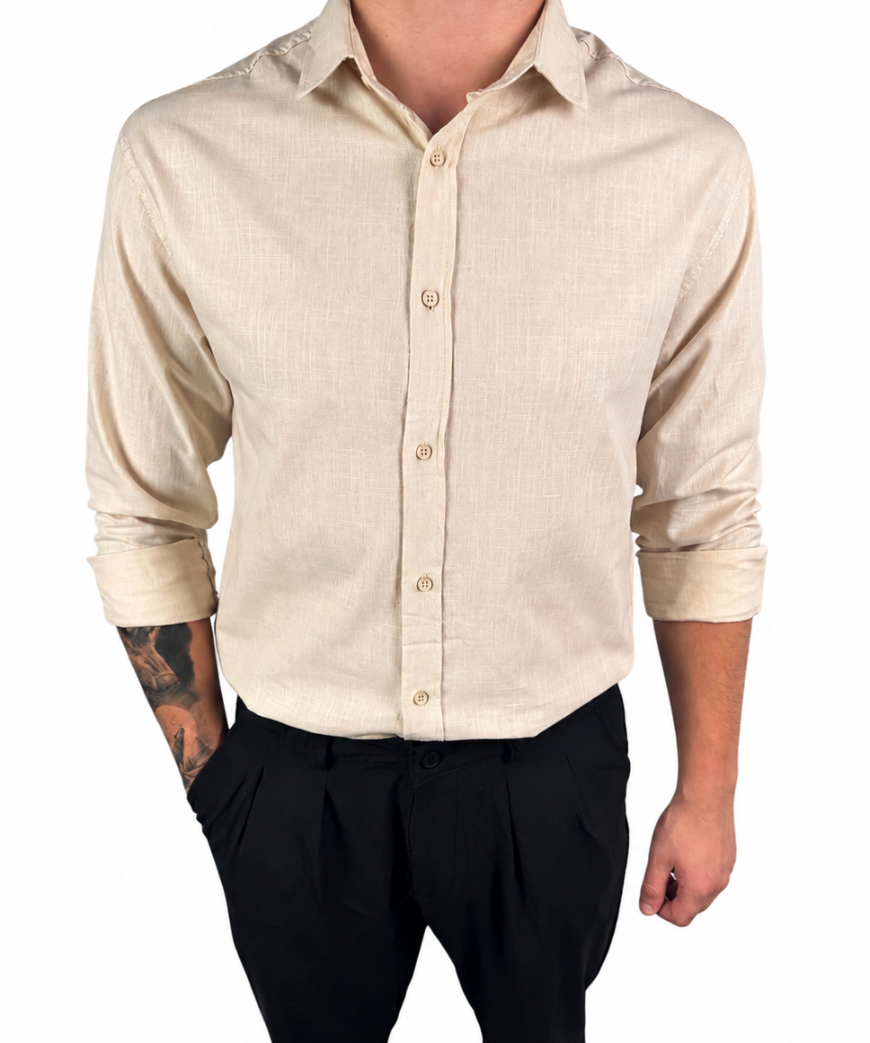 A man wearing a light beige linen button-down shirt with black trousers, shown from the neck down against a plain white background.