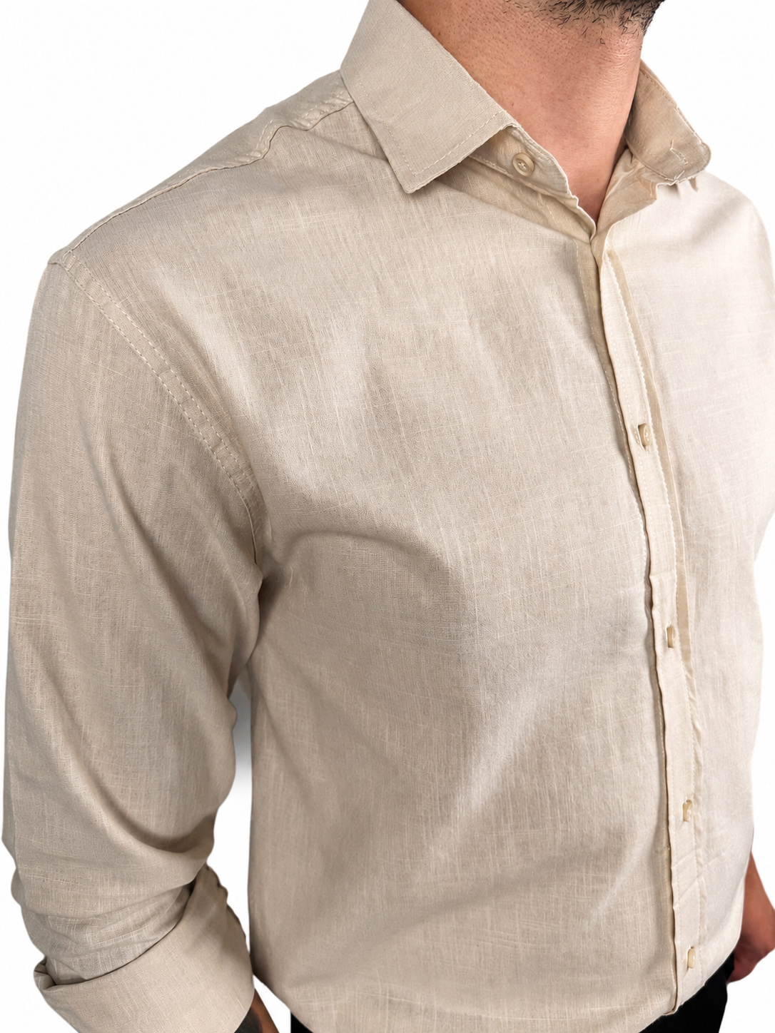 A man wearing a light beige linen button-down shirt, cropped from the neck down, showing the fabric texture and collar detail against a white background.