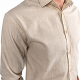 A man wearing a light beige linen button-down shirt, cropped from the neck down, showing the fabric texture and collar detail against a white background.