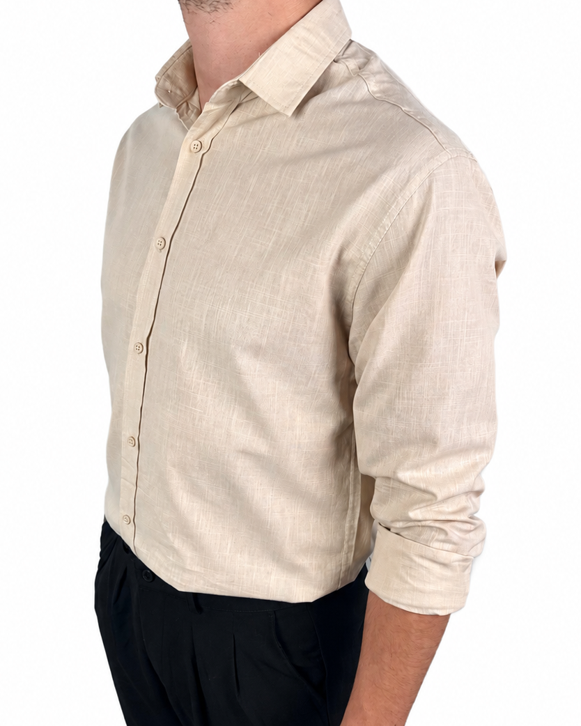 A man wearing a light beige linen button-down shirt with black trousers, shown from a side profile against a plain white background.