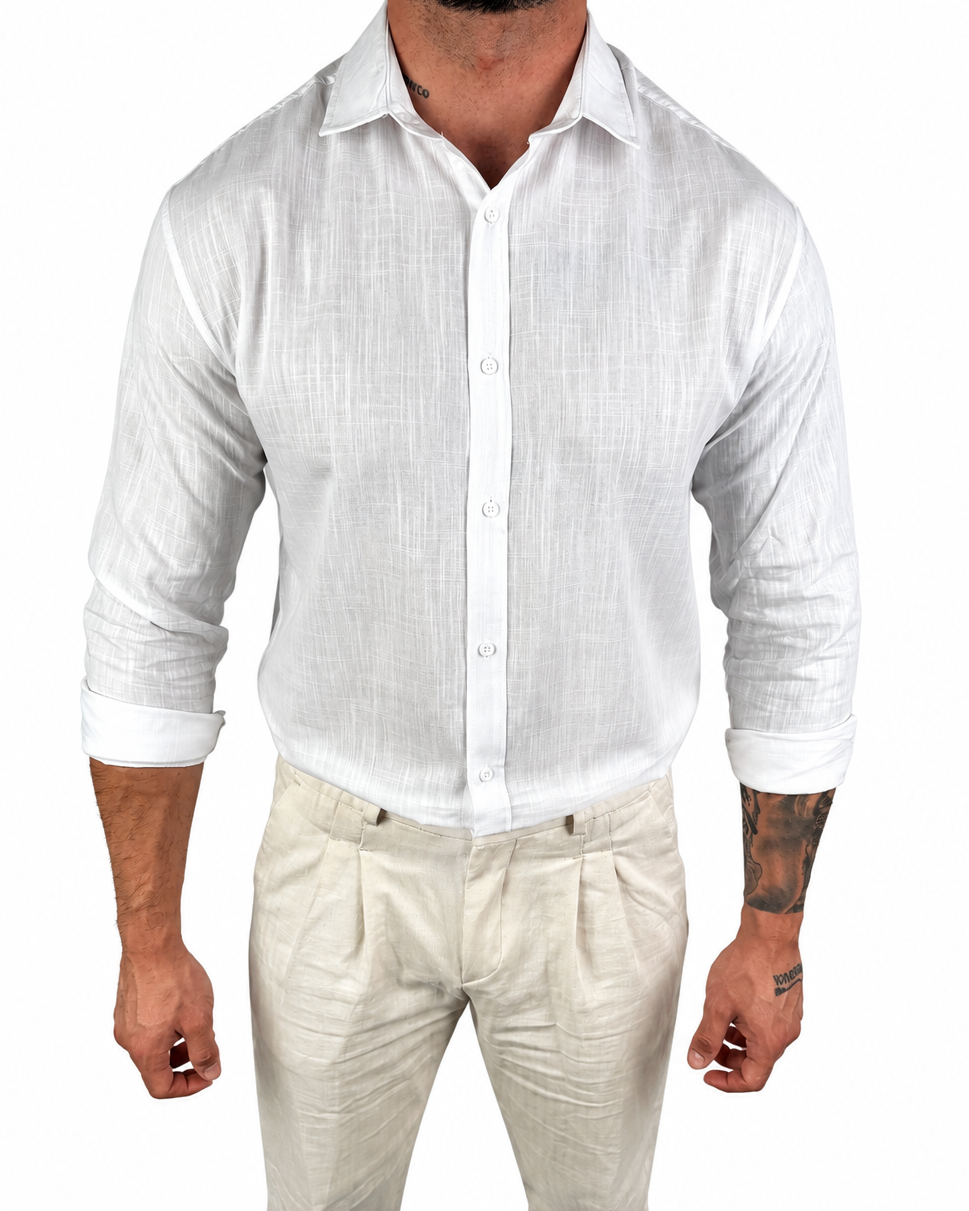 A man wearing a white long-sleeve linen button-up shirt and light beige linen trousers, shown from the neck down against a plain white background.