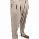 A person wearing light beige pleated trousers and brown slip-on shoes, shown from the waist down against a plain white background.
