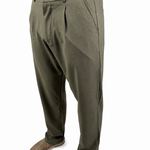 A person wearing olive green pleated trousers with a brown shirt and brown shoes, shown from the waist down against a plain white background.