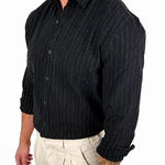 A man wearing a black long-sleeve button-up shirt with thin white vertical pinstripes and light beige trousers, shown from the waist up against a plain white background.
