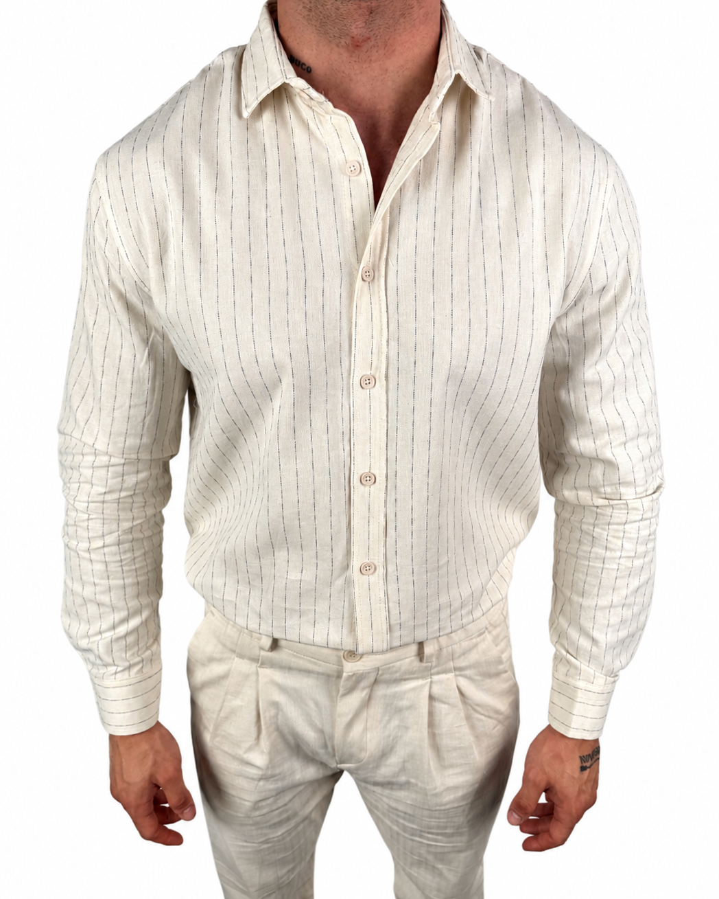 A man wearing a cream-colored linen button-down shirt with thin vertical blue stripes and matching linen trousers, shown from the neck down against a white background.