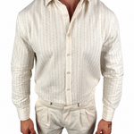 A man wearing a cream-colored linen button-down shirt with thin vertical blue stripes and matching linen trousers, shown from the neck down against a white background.