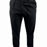 Black slim-fit trousers shown on a model from the waist down, paired with a tan shirt and beige slip-on shoes against a plain white background.