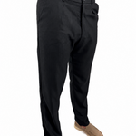 A person wearing black slim-fit dress pants with tan slip-on shoes, shown from the waist down against a plain white background.