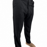 A person wearing black slim-fit dress pants with tan slip-on shoes, shown from the waist down against a plain white background.