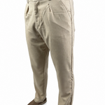 A person wearing light beige chinos or casual trousers, paired with brown suede shoes and a brown shirt, shown from the waist down on a white background.