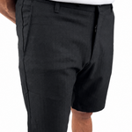 A person wearing black knee-length shorts with a white top and tan shoes, shown from the waist down against a plain white background.