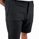A person wearing black knee-length shorts with a white top and tan shoes, shown from the waist down against a plain white background.