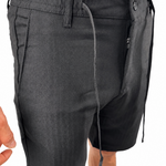 Dark gray drawstring shorts with a unique asymmetrical zipper closure and side pockets, shown on a model against a white background.