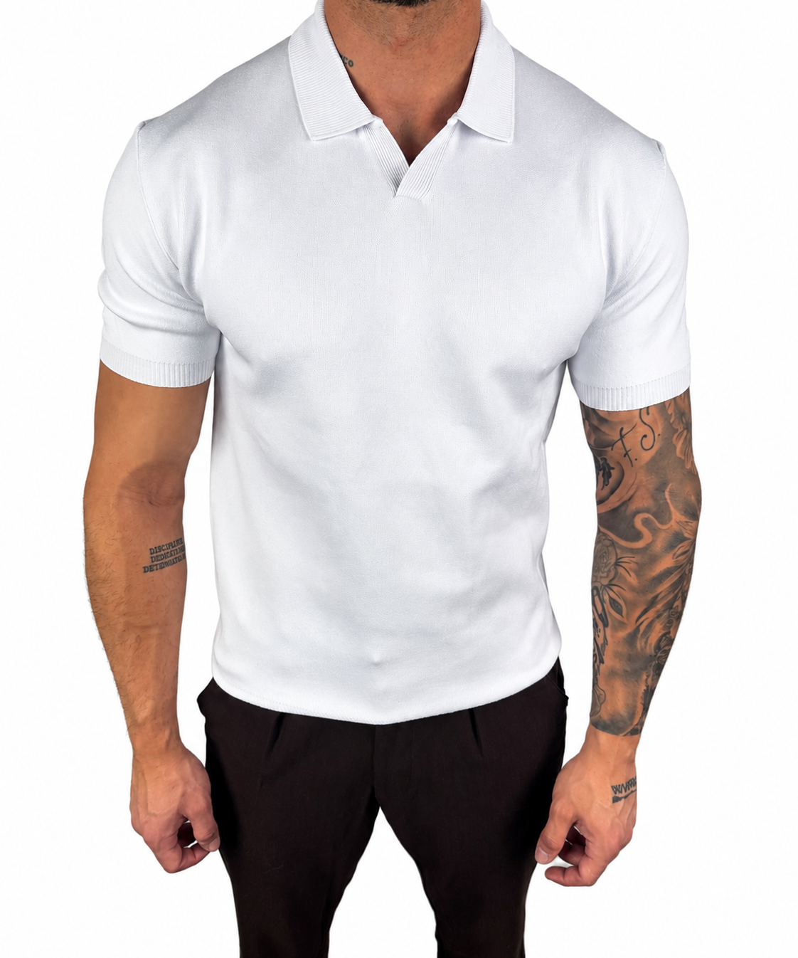 A man wearing a fitted white short-sleeve polo shirt with black trousers, shown from the neck down against a plain white background.