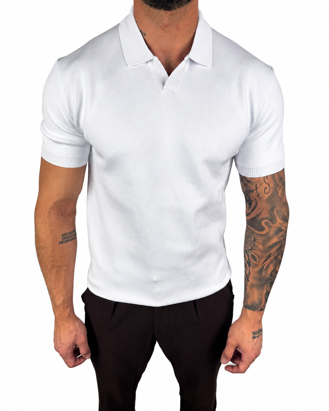 A man wearing a fitted white short-sleeve polo shirt with black trousers, shown from the neck down against a plain white background.