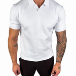 A man wearing a fitted white short-sleeve polo shirt with black trousers, shown from the neck down against a plain white background.