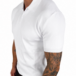A man wearing a white short-sleeve polo shirt and black pants, shown from the side against a plain white background.