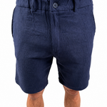 A person wearing navy blue textured shorts, shown from the waist down against a plain white background.